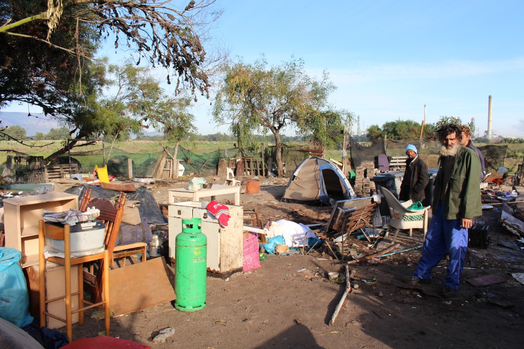 Residents and possessions in a torn down encampment
