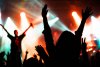 People raising hands at a rock concert