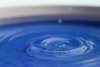 Water drops cause ripples in a bucket of water